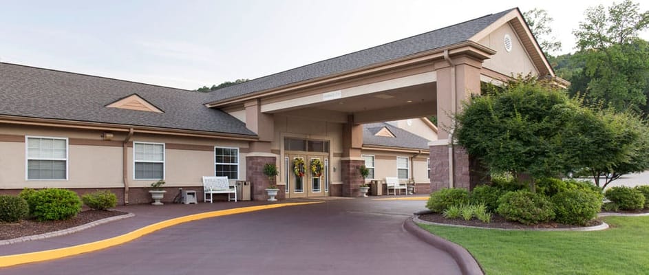 Front entrance of an assisted living facility with landscaping