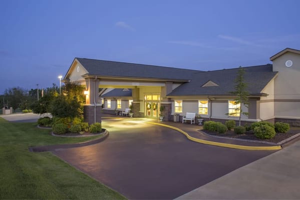 Exterior view of a senior living facility at dusk