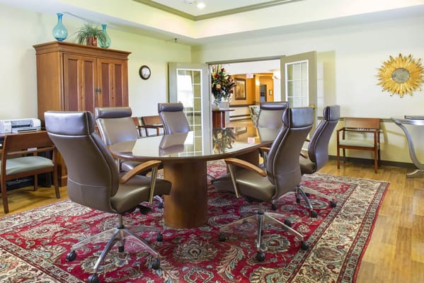 A bright conference room with a round table and chairs