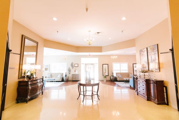 A bright lobby area with seating and decor