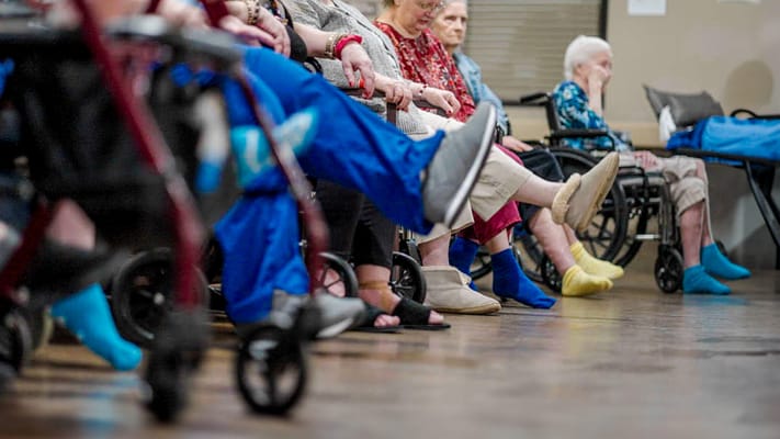 Residents engaging in group activity seated in a social area