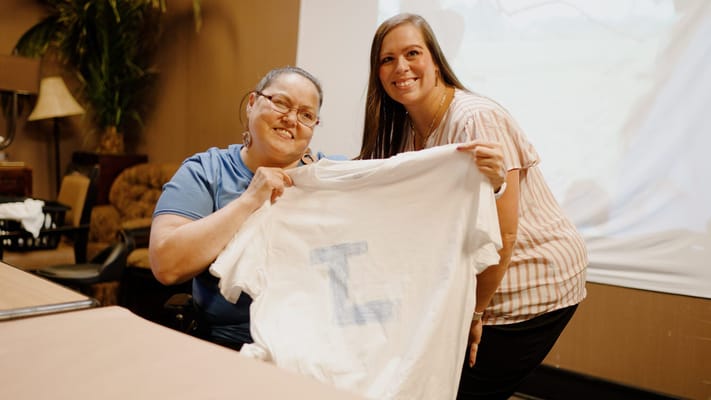 Residents and staff sharing a special moment with a t-shirt