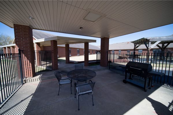 Outdoor seating area with grill and tables