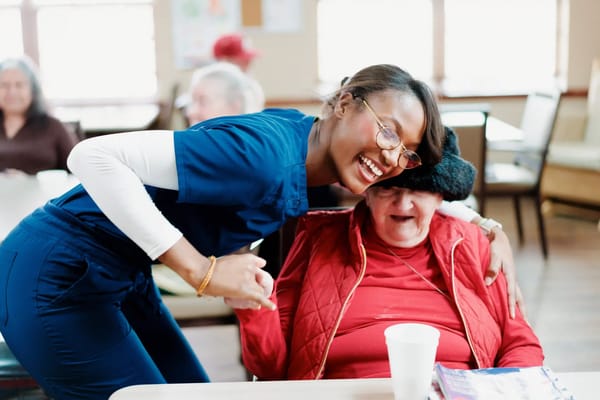 Care staff and resident enjoying a moment in a common area