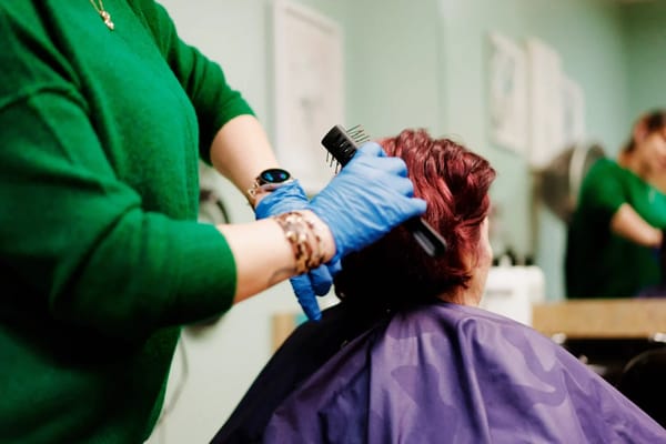 A resident receiving a haircut in a salon