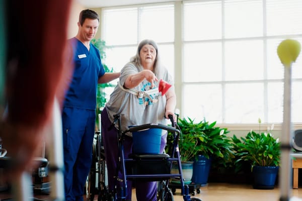 A resident receiving assistance in a bright common area