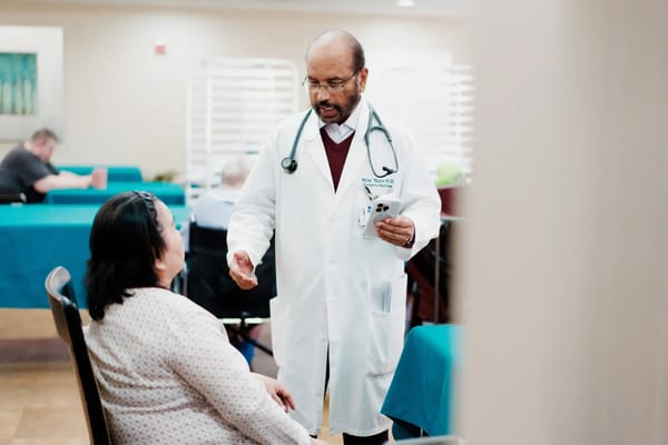Doctor consulting with a resident in the common area