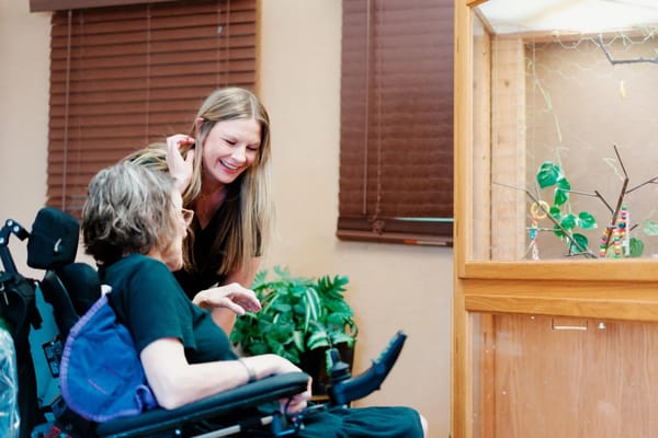 Staff member interacting with a resident in a cozy common area