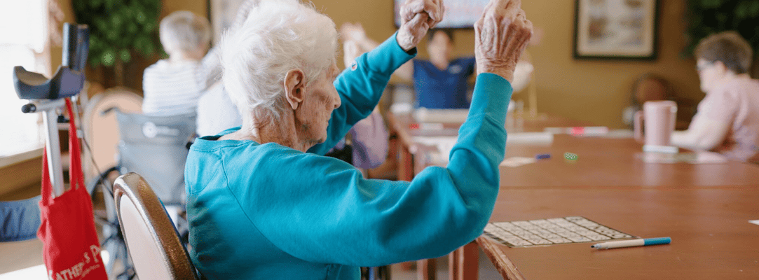 Residents engaged in a bingo game in a common area