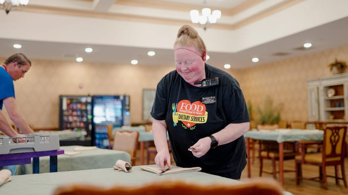 Staff preparing for a meal service in a dining area
