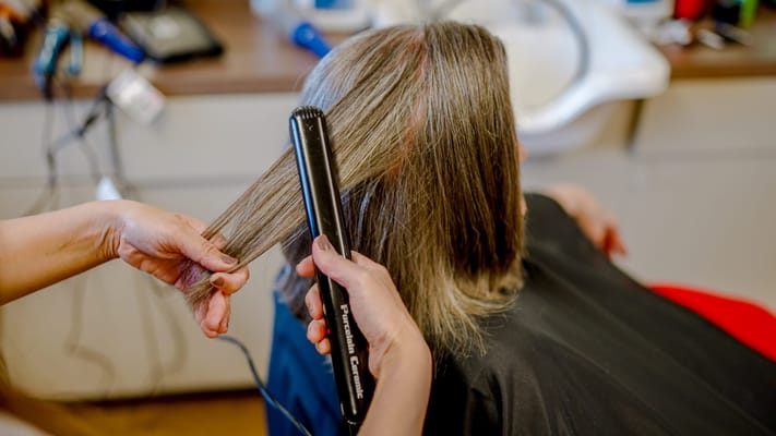 Styling hair in an onsite beauty salon