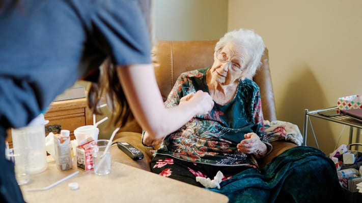 Caregiver assisting an elderly resident at home
