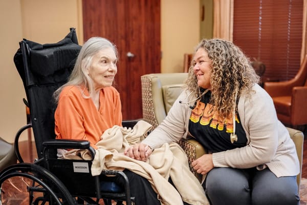 A caregiver interacting with a resident in a cozy setting