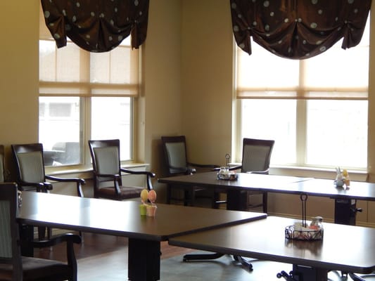 Bright communal area with tables and chairs