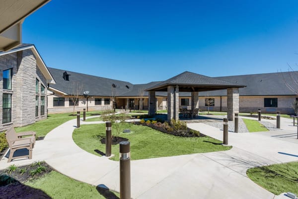 Courtyard with gazebo and pathway in a senior living facility