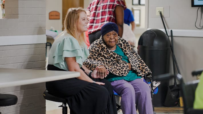 A staff member and a resident sharing a moment indoors