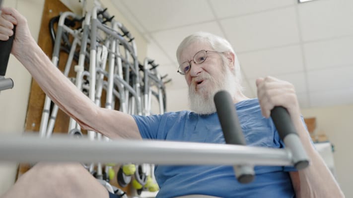 Senior man exercising in a therapy room