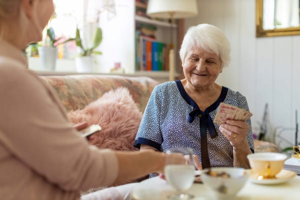 Residents enjoying a card game in a cozy common area