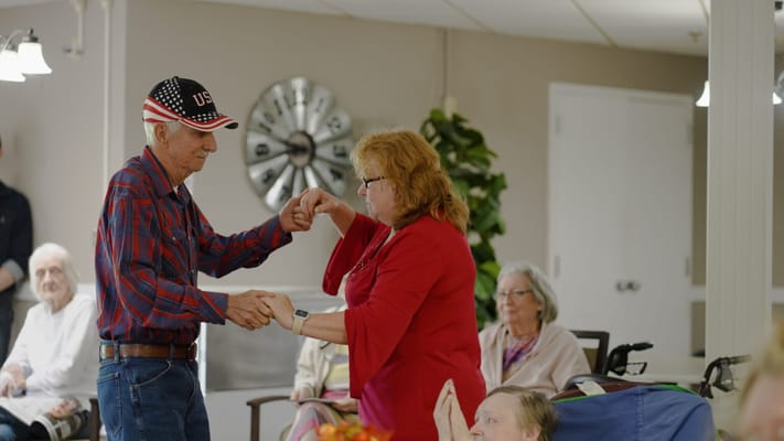 Residents dancing in a lively common area