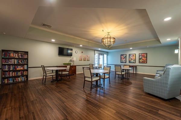 Common area with tables and seating for residents