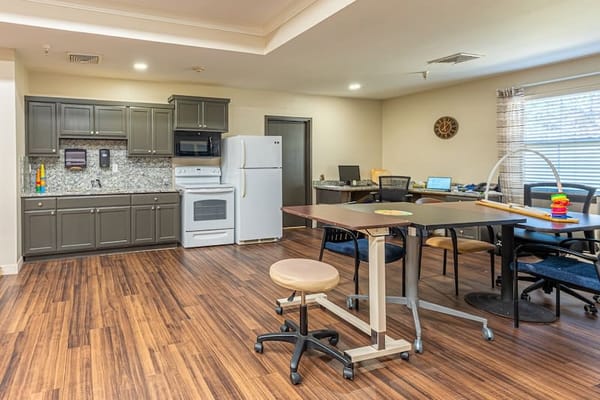 Interior view of a shared activity room with kitchen facilities