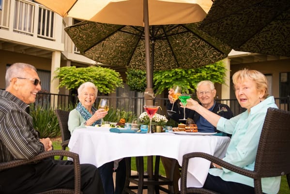 Group of seniors enjoying drinks on a patio