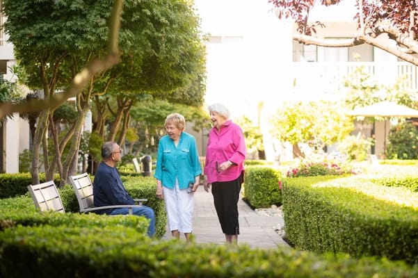 Residents enjoying a walk in the garden area