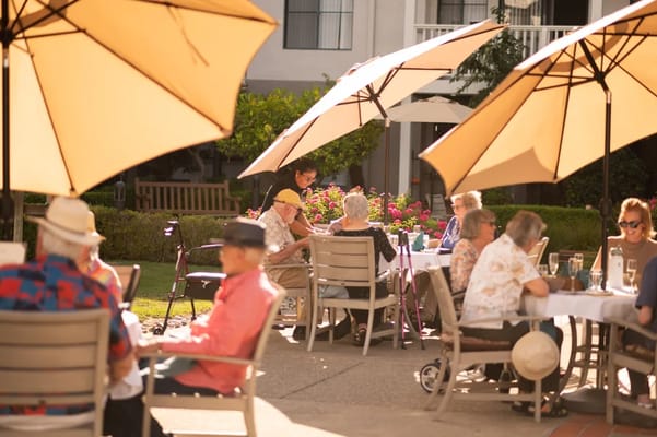 Residents enjoying lunch on a sunny patio