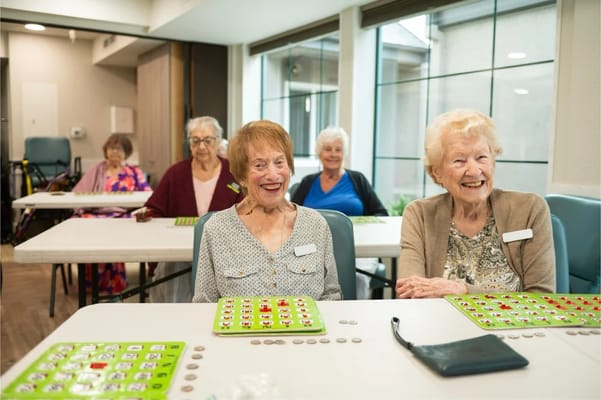 Residents enjoying a bingo game in a communal area
