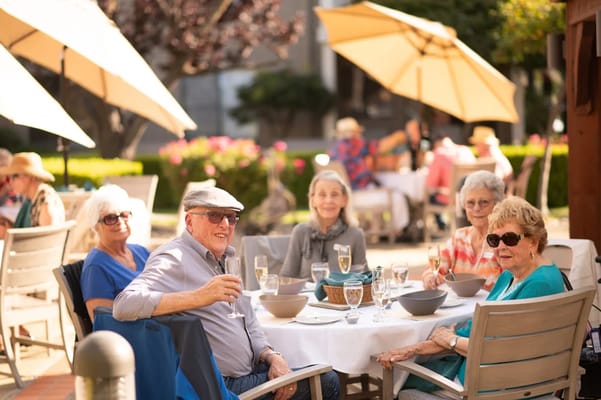 Residents enjoying drinks in an outdoor dining area