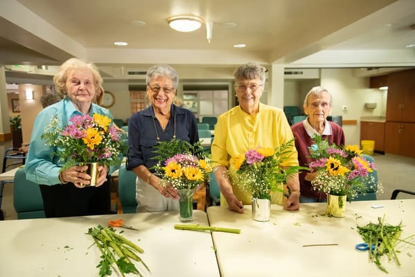 Residents making flower arrangements in a common area