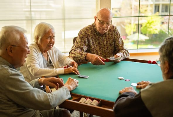 Residents enjoying a card game in a common area
