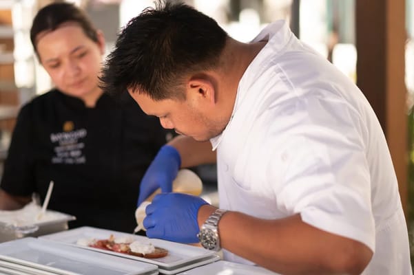 Chefs preparing a meal in a kitchen setting