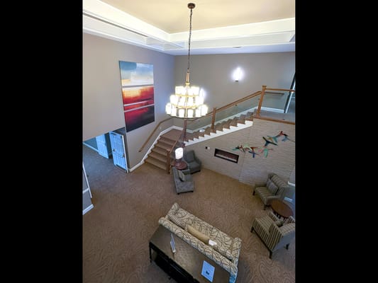 Bright lobby area with stairs and seating