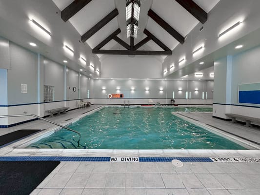 Indoor swimming pool with seating areas