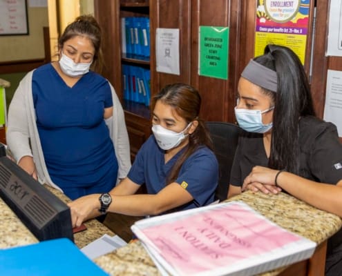Staff members assisting at the reception desk