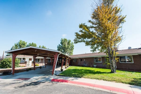 Exterior view of a senior living facility with trees