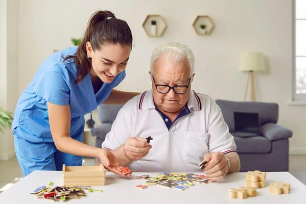 Staff assisting a resident with a puzzle activity