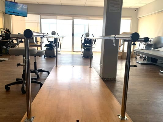 Rehabilitation gym with parallel bars and equipment