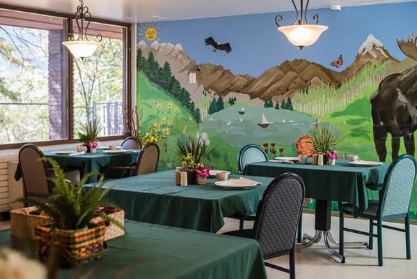 Dining area with mural and tables set for meals