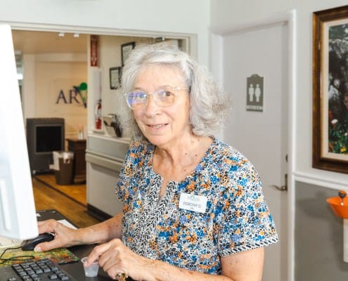 Staff member assisting at a reception desk
