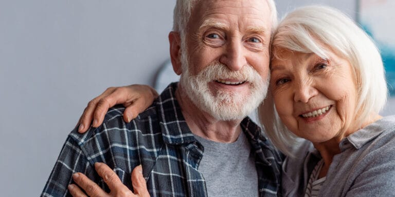Happy senior couple smiling together in a cozy setting