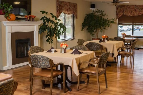 Dining area with tables and chairs in bright setting