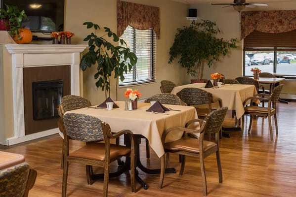 Dining area with tables and chairs in bright setting