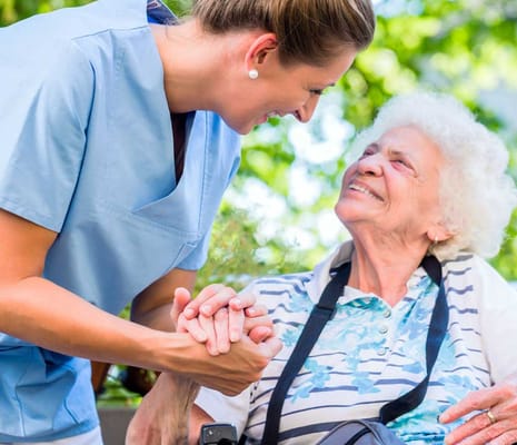 A caregiver interacting warmly with a resident