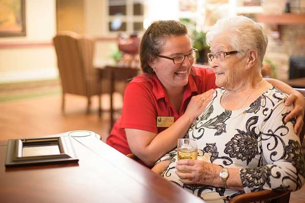Staff member engaging with a resident in a cozy setting