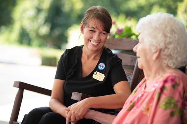 A staff member engaging with a resident outdoors