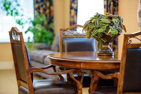 Cozy seating area with a table and floral arrangement