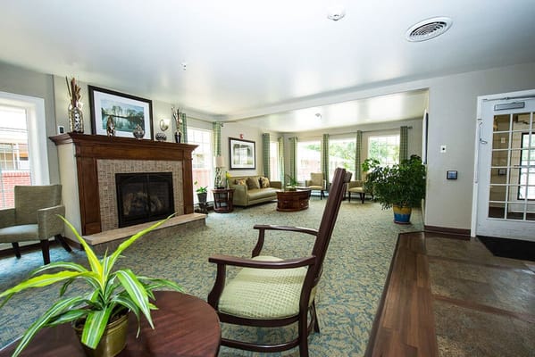 Bright common area with seating and a fireplace