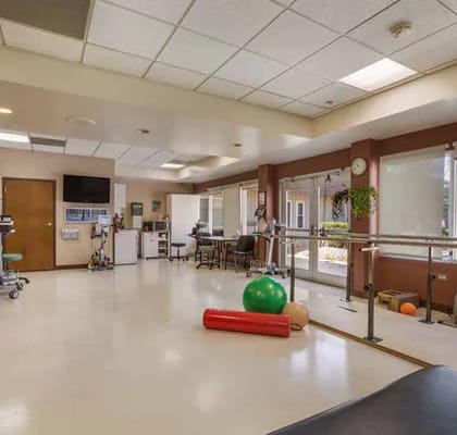 Physical therapy room with exercise equipment and rehabilitation tools